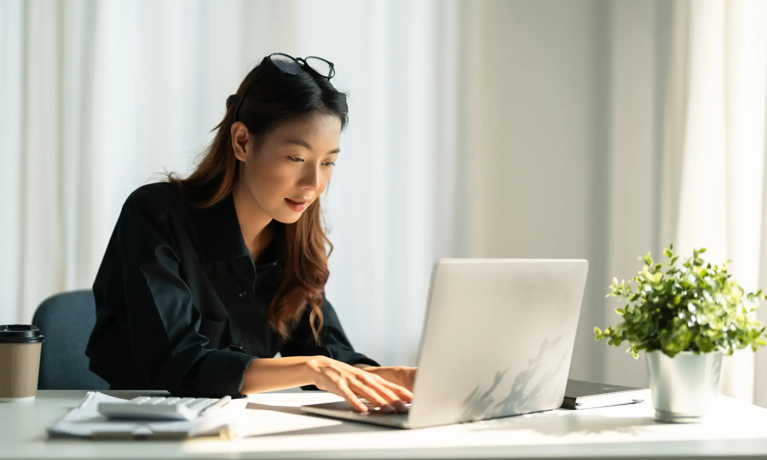 Finance professional in AP working on laptop