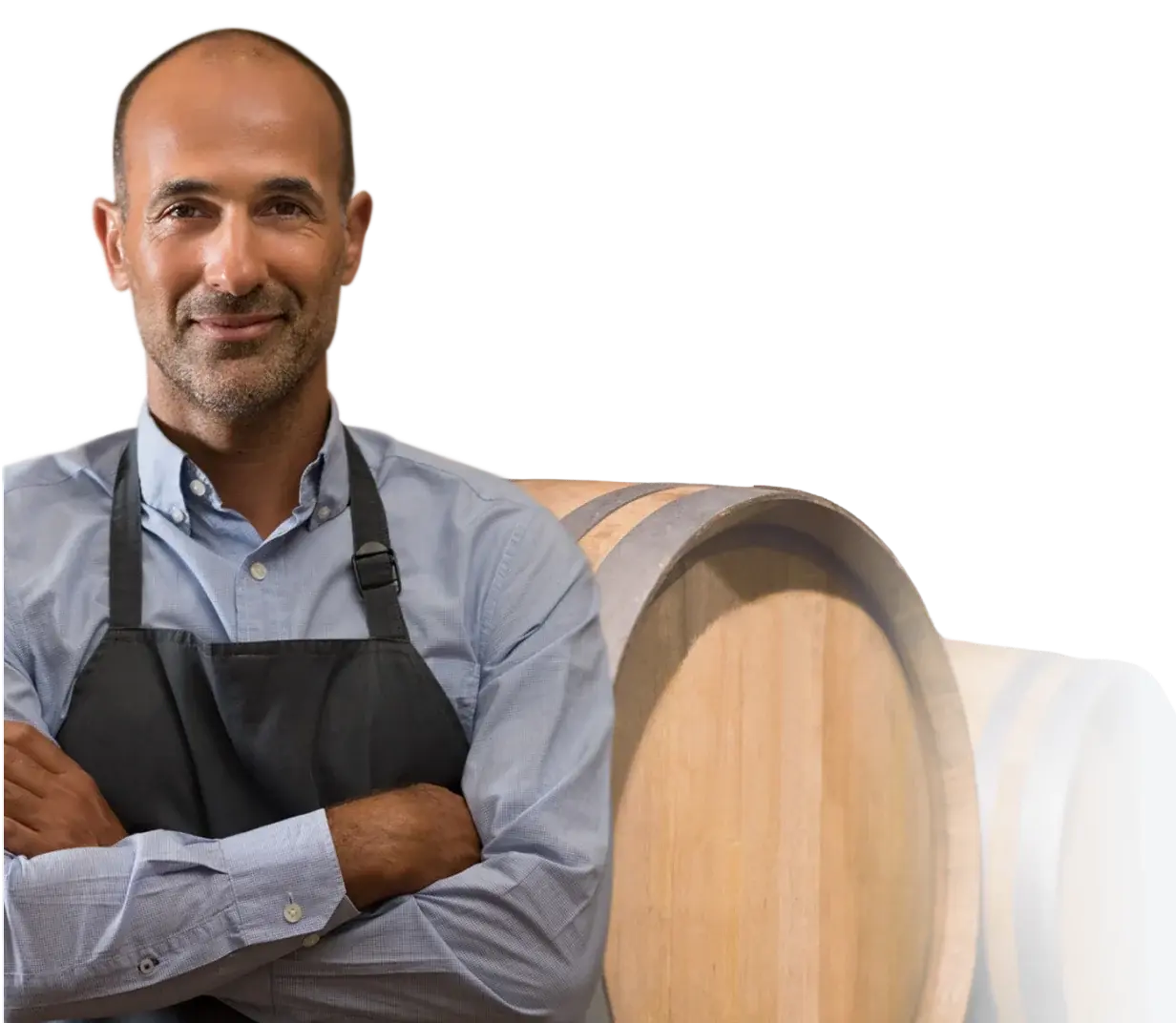Winemaker standing in front of oak barrels in a cellar